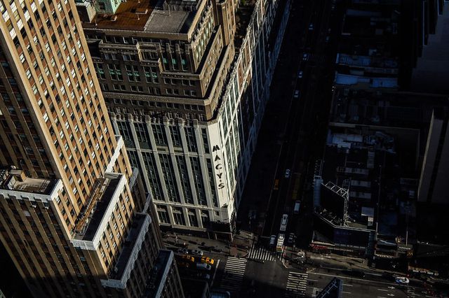 An aerial view of a midtown skyscraper with shadows.